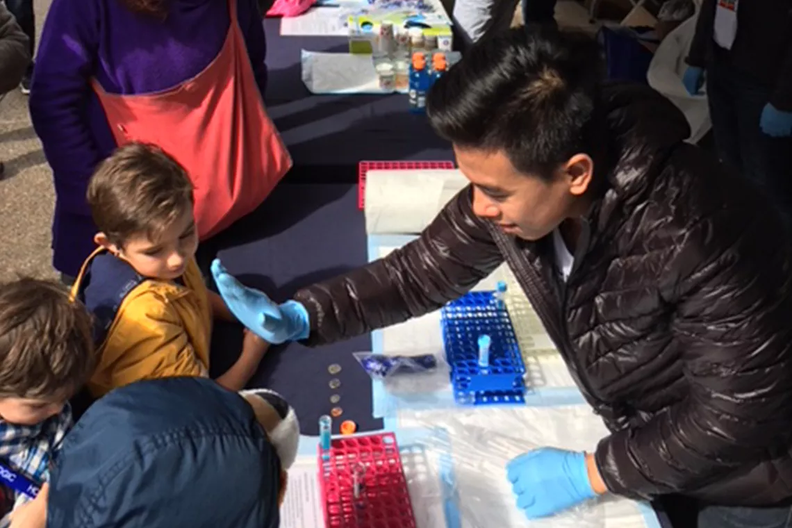 Un travailleur du secteur de l’événementiel fait un « high 5 » à des enfants pour s’amuser